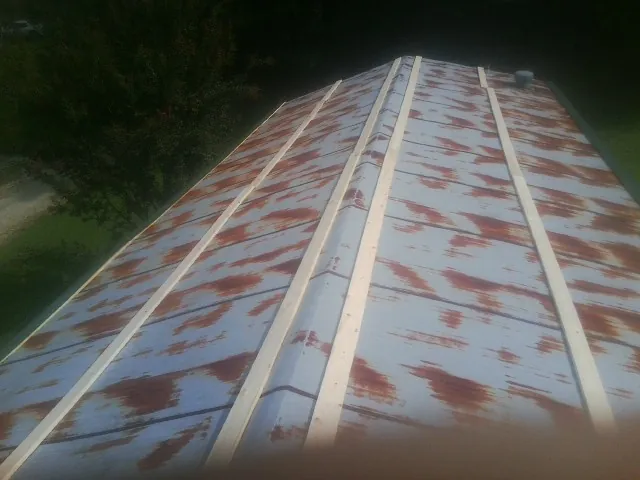 Rusted metal roof panels with new wood purlins before replacement — Storm Damage Roof Repair in Tuckerton by Roofing Brothers